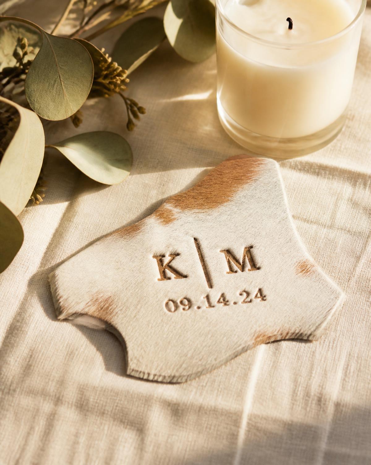 Cowhide wedding keepsake branded with initials and a wedding date